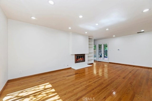 unfurnished living room featuring hardwood / wood-style floors