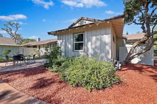 view of side of home with a patio