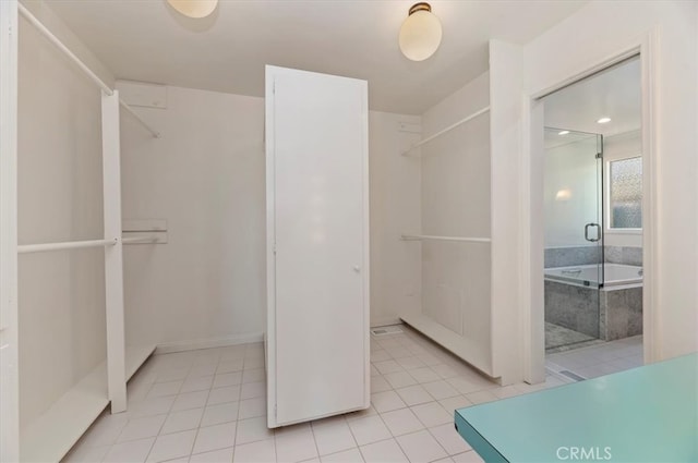 spacious closet with light tile patterned floors