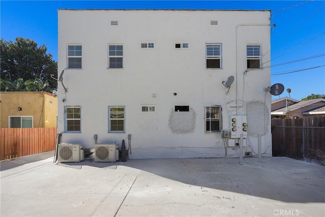 back of property featuring ac unit and a patio