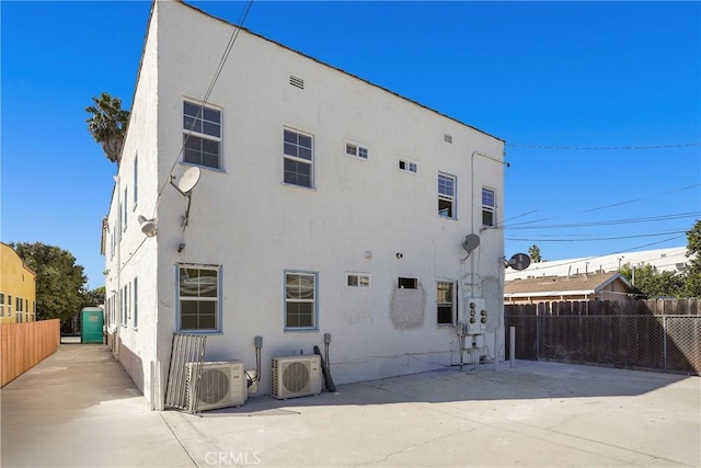 back of property featuring ac unit