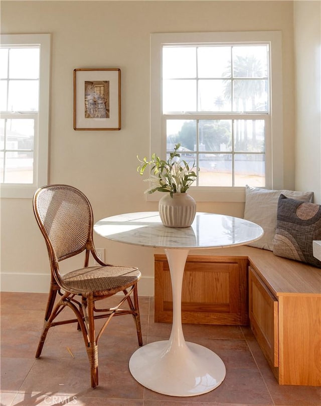 tiled dining room with breakfast area and plenty of natural light