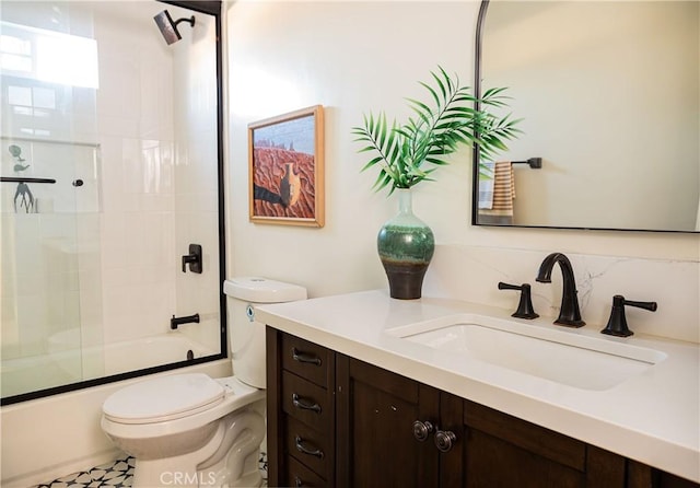 full bathroom featuring backsplash, vanity, bath / shower combo with glass door, and toilet