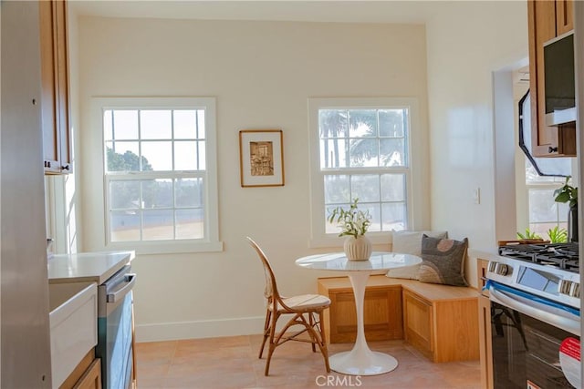 dining space featuring a wealth of natural light and light tile patterned floors