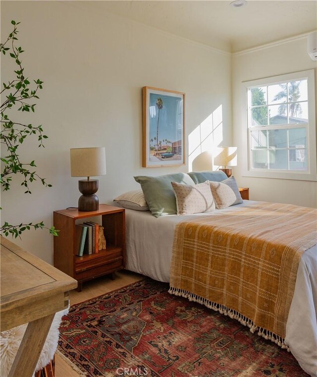 bedroom with hardwood / wood-style flooring