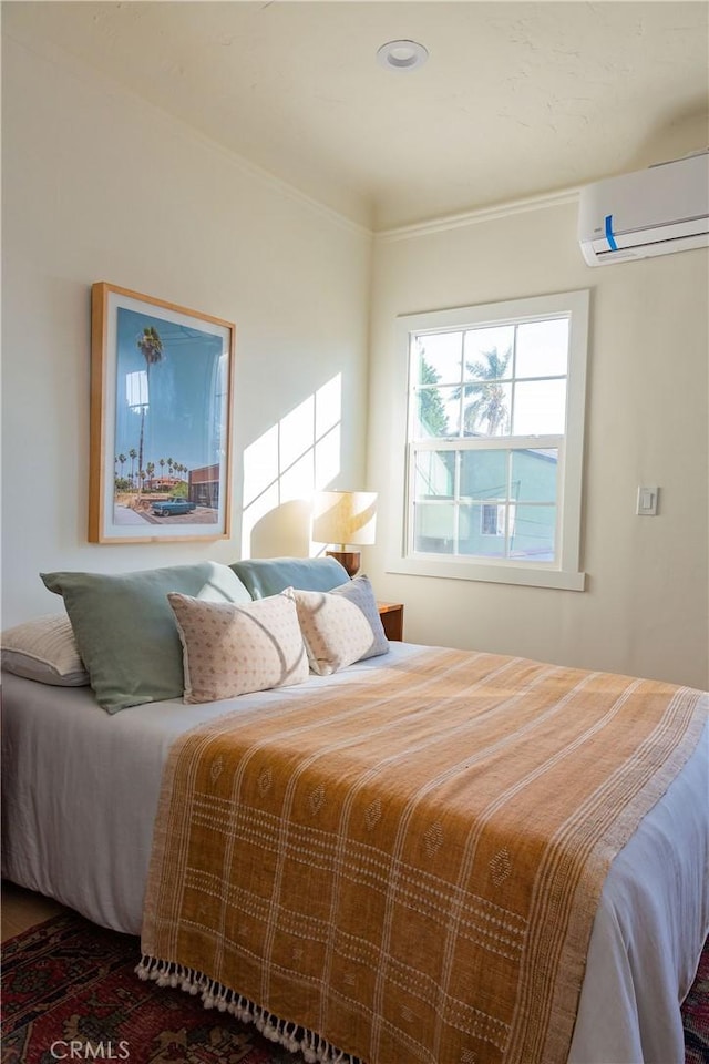 bedroom featuring a wall mounted AC