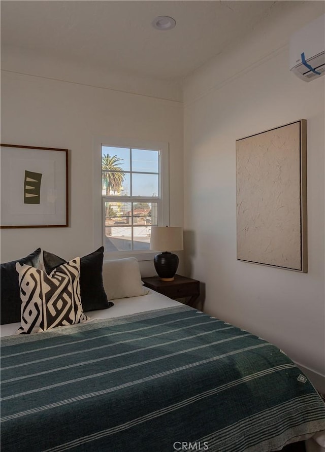 bedroom with an AC wall unit