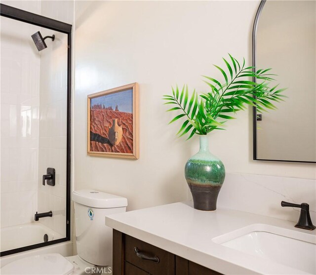 full bathroom featuring vanity, toilet, and enclosed tub / shower combo