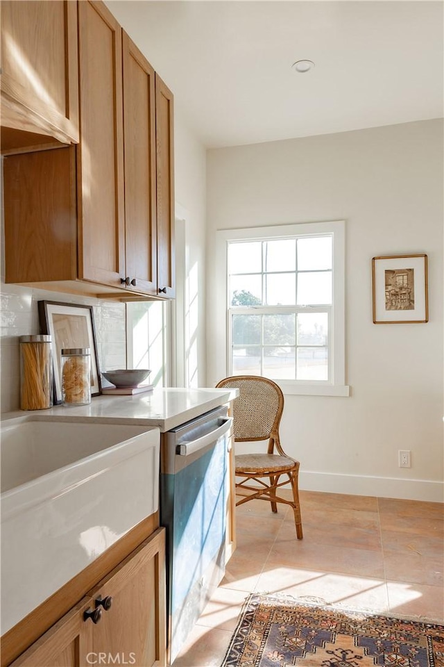 interior space with dishwasher and light tile patterned flooring