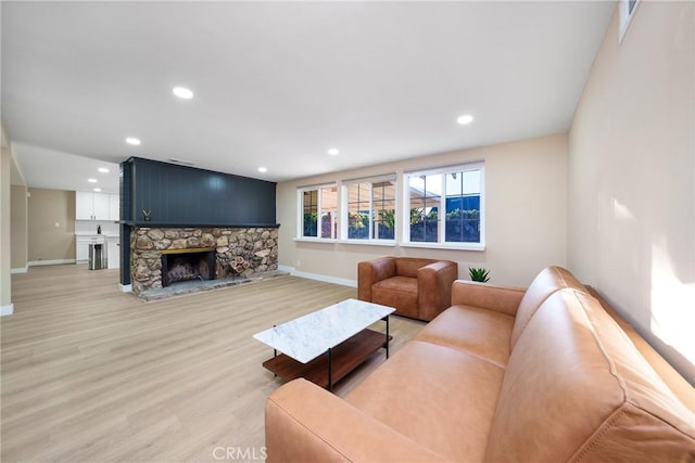 living room with a fireplace and hardwood / wood-style floors