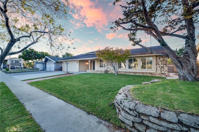 single story home featuring a garage, cooling unit, and a lawn