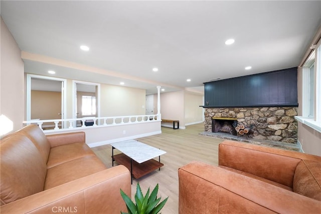 living room with a fireplace and light hardwood / wood-style flooring