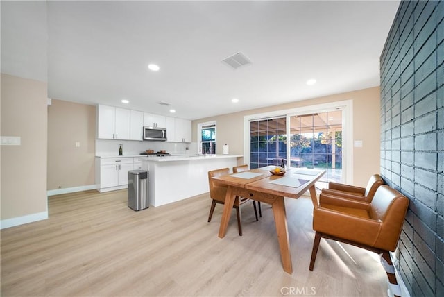 dining area with light wood-type flooring