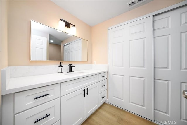 bathroom featuring vanity and hardwood / wood-style flooring