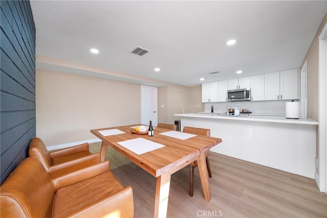 dining area with light wood-type flooring