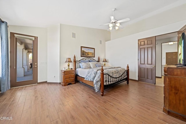 bedroom with ceiling fan, light hardwood / wood-style floors, and lofted ceiling