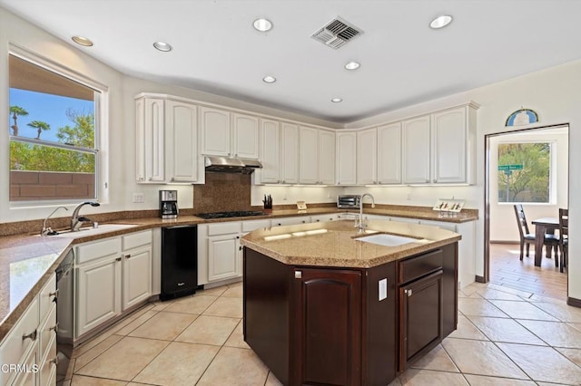 kitchen featuring light tile patterned flooring, black gas stovetop, and sink