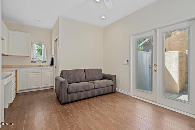 living room featuring ceiling fan, a healthy amount of sunlight, and light hardwood / wood-style floors