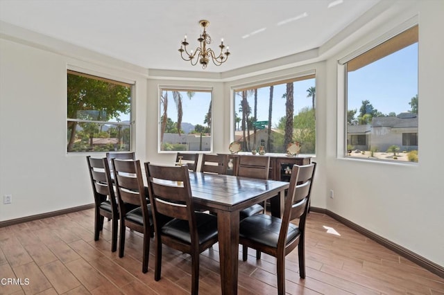 dining space featuring an inviting chandelier and light hardwood / wood-style flooring