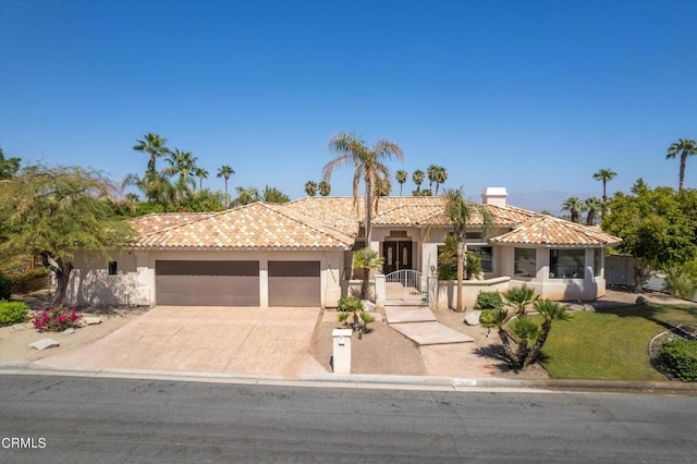 mediterranean / spanish-style house with a garage