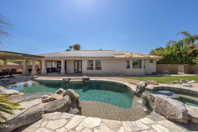 view of pool featuring an in ground hot tub, french doors, and a patio