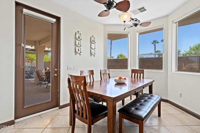 dining area with ceiling fan, a healthy amount of sunlight, and light tile patterned flooring