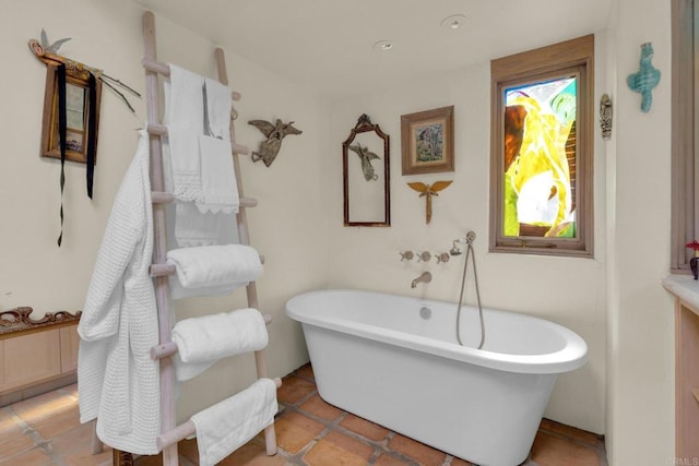 bathroom with tile patterned floors and a washtub