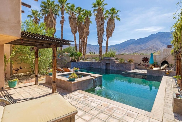 view of pool with an in ground hot tub, a patio area, a pergola, pool water feature, and a mountain view