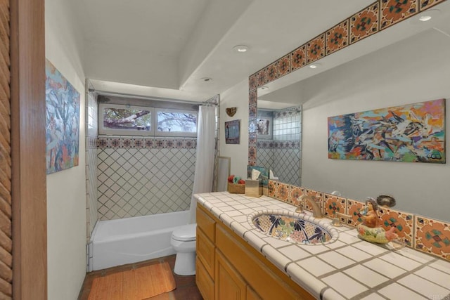 full bathroom featuring toilet, hardwood / wood-style flooring, vanity, and shower / tub combo