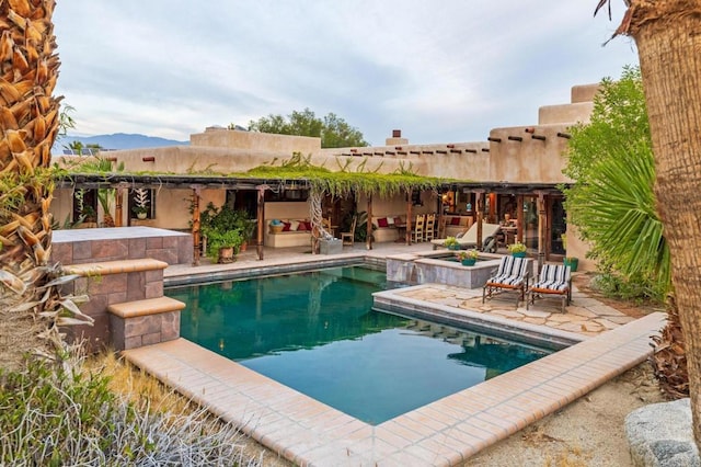 view of swimming pool featuring a patio and a mountain view