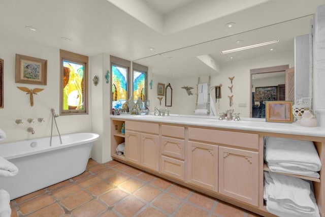 bathroom with vanity, tile patterned floors, and a washtub