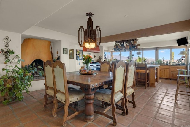 dining area featuring a notable chandelier and light tile patterned flooring