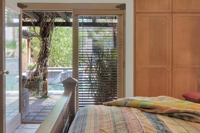 bedroom featuring multiple windows and access to exterior