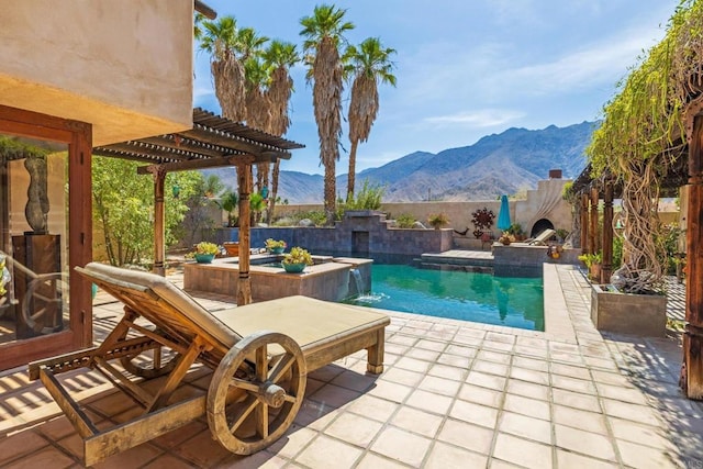 view of pool with a pergola, a mountain view, pool water feature, and a patio