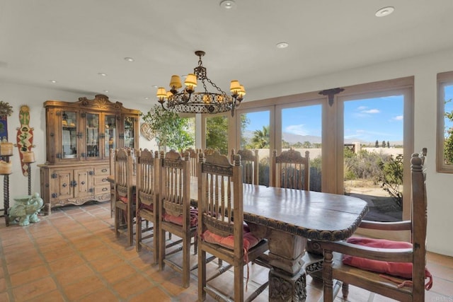 tiled dining space featuring a notable chandelier