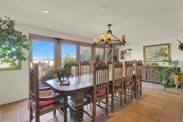 tiled dining room with a chandelier