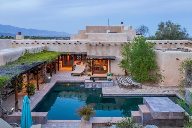 view of swimming pool featuring a patio and a mountain view