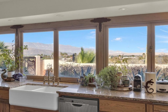 kitchen featuring a mountain view, a healthy amount of sunlight, and dishwasher