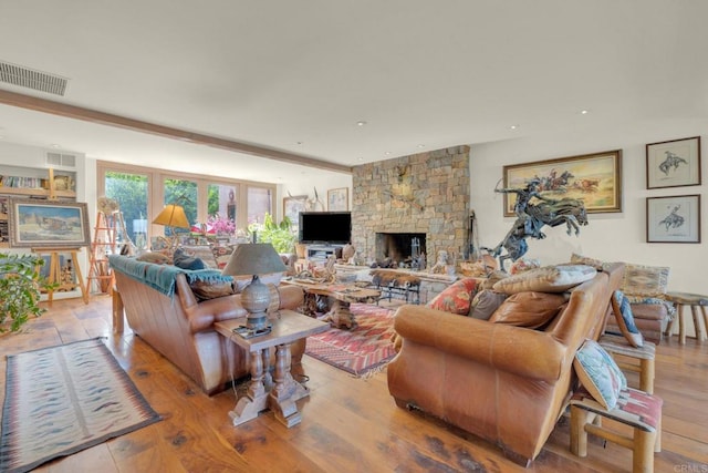 living room with light hardwood / wood-style floors and a fireplace