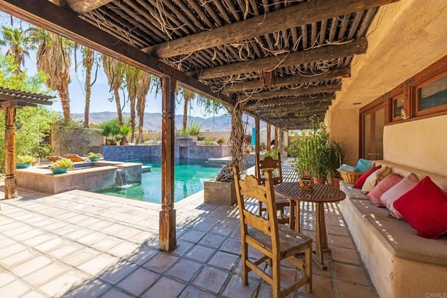 view of patio featuring an outdoor hangout area, a swimming pool with hot tub, pool water feature, and a mountain view