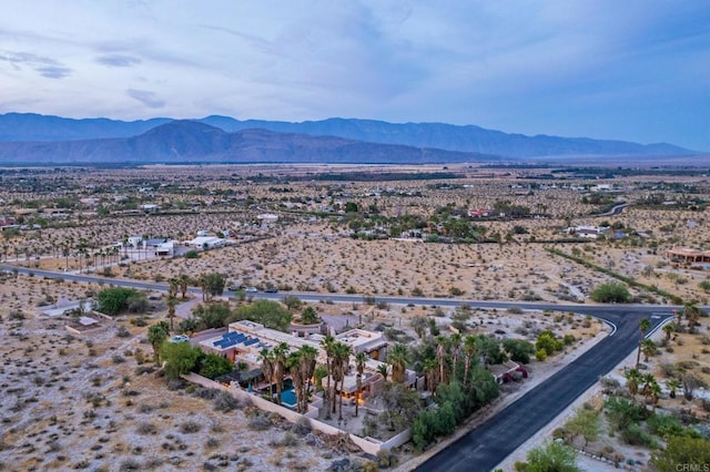 birds eye view of property with a mountain view