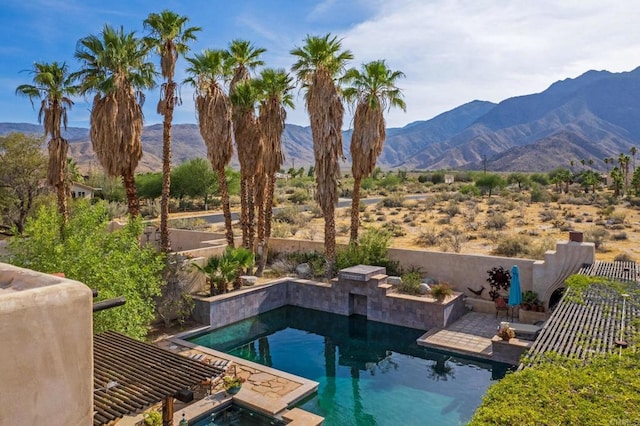 view of pool with a mountain view and a jacuzzi