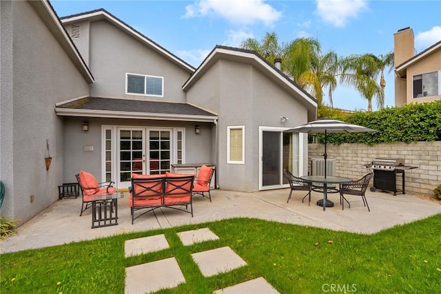 rear view of property with an outdoor living space and a patio area