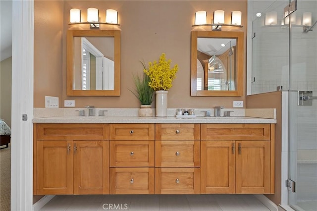 bathroom featuring tile patterned flooring, vanity, and an enclosed shower