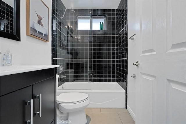 full bathroom featuring toilet, vanity, tile patterned floors, and tiled shower / bath