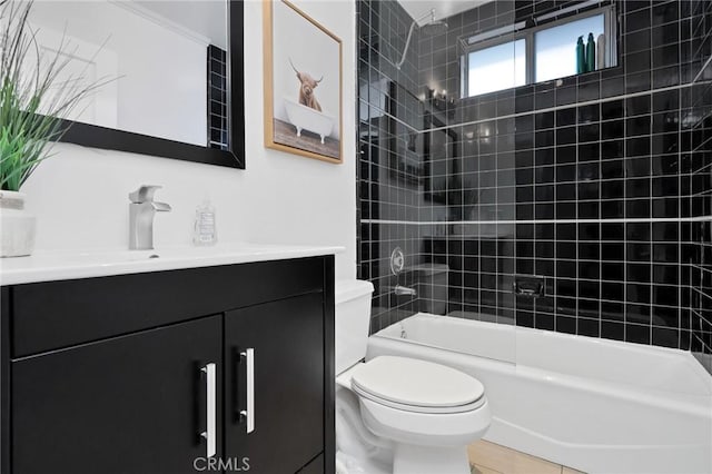 full bathroom with tile patterned floors, vanity, tiled shower / bath combo, and toilet