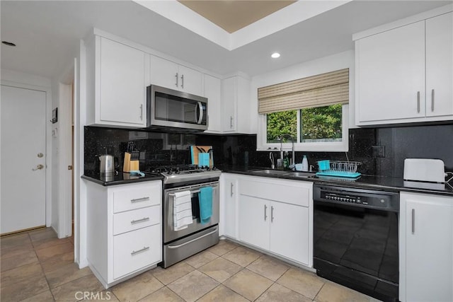 kitchen with white cabinetry, decorative backsplash, and appliances with stainless steel finishes