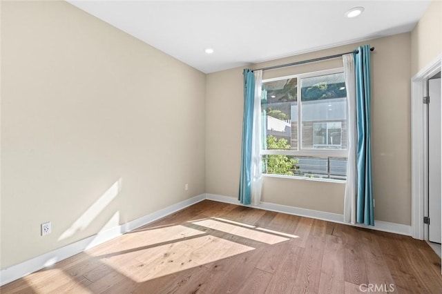 unfurnished room with light hardwood / wood-style flooring