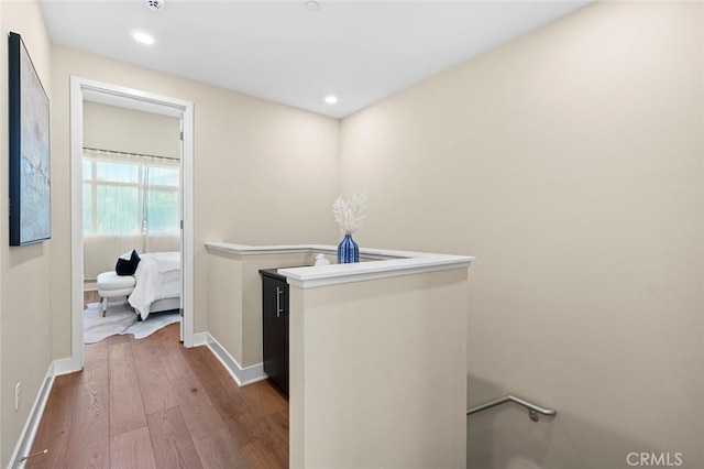 clothes washing area with wood-type flooring