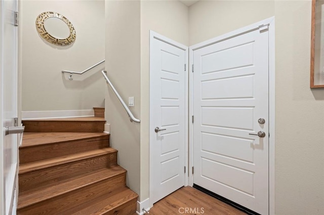 stairs with hardwood / wood-style flooring